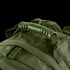 Close-up of the Condor Medium Assault Backpack 30L in green, highlighting its sturdy plastic handle, durable zipper pulls, and reinforced fabric stitching.